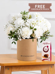 Pure Bliss Hatbox free chocolate pouch – Indulge in the pure and serene beauty of our "Pure Bliss" arrangement, featuring pristine...