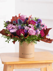 Autumn Purple Majesty Hatbox – Experience autumn's beauty with our Autumn Purple Majesty arrangement, featuring purple roses, purple carnations, thistles,...