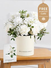 Sympathy Pure Bliss - Hatbox with Free Sympathy card – Indulge in the pure and serene beauty of our "Pure Bliss" arrangement, featuring pristine...