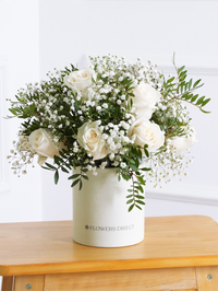 White Roses Hatbox – Celebrate any special occasion with our stunning 12 white roses hatbox, elegantly complemented by gypsophillia and...