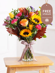 Autumn Charm Vase Free Upgrade – Brighten up any room with our "Autumn Charm" arrangement, featuring stunning sunflowers, cerise carnations,...