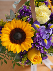 Iris Bliss Basket – The Iris Bliss – Basket is a cheerful mix of Blue Iris, Sunflowers, Yellow...