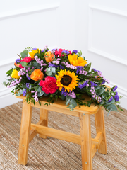 Colour Burst Spray – This stunning arrangement, bursting with vibrant hues of sunflowers, orange roses, yellow roses, pink...