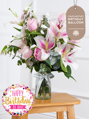 Birthday Pink Roses and Pink Lily - Vase (Complimentary Birthday Balloon) – This is a very elegant bouquet, featuring large-headed pink roses and scented pink oriental...