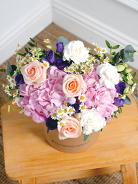Sweet Pastel Hatbox Free Upgrade –  Brighten up any space with our 'Sweet Pastel' arrangement, featuring soft pink hydrangeas, peach...