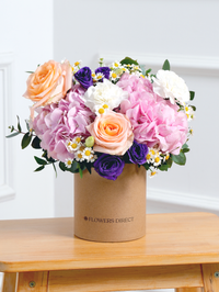 Sweet Pastel Hatbox –  Brighten up any space with our 'Sweet Pastel' arrangement, featuring soft pink hydrangeas, peach...