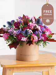 Autumn Purple Majesty Hatbox Free Upgrade –  Experience autumn's beauty with our Autumn Purple Majesty arrangement, featuring purple roses, purple carnations,...