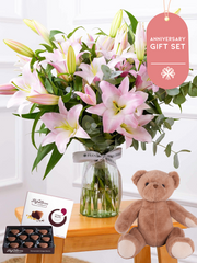 Anniversary Pink Lily - Vase Gift Set – The Pink Lily in a vase adorned with eucalyptus and pistach leaves serves as...