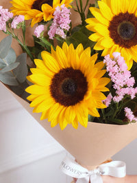Pink Glow Bunch! with Free Chocolate Set – Brighten any day with this warm mix of sunflowers and delicate pink statice. Paired...