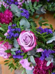 Purple Majesty Wreath – This Purple Majesty Wreath, adorned with exquisite purple roses, pink chrysanth, lilacs, blue statice,...