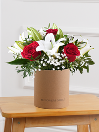 Red Roses and White Lily - Hatbox – Our Red Roses and White Lily Hatbox is a bold and striking floral arrangement, featuring...