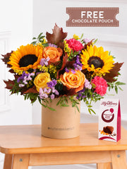 Autumn Charm Hatbox free chocolate pouch – Embrace the season with our Autumn Charm hatbox, featuring yellow and orange roses, cerise...