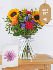 Colour Burst Vase Gift Set –  Brighten up any room with our "Colour Burst" arrangement, featuring stunning sunflowers, cerise carnations,...