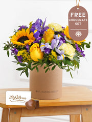 Iris Bliss - Hatbox with Free Chocolate Set – Bright and full of charm, Iris Bliss is a vibrant hatbox arrangement for any...
