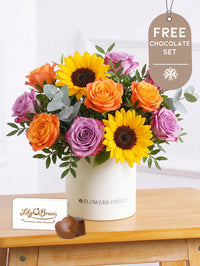 Sunflower Hatbox with Free Chocolate Set –  Give the gift of pure joy with this vibrant Sunny Day Hatbox floral arrangement! The golden...