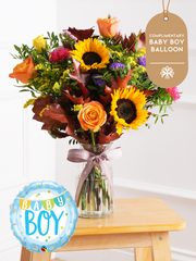 Baby Boy Autumn Charm - Vase (Complimentary Baby Boy Balloon) – The Baby Boy Colour Burst Vase is a vibrant floral arrangement that radiates joy...