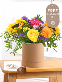 Thank You Colour Burst - Hatbox with Free Chocolate Set –  Brighten up any room with our "Colour Burst" arrangement, featuring stunning sunflowers, cerise carnations,...