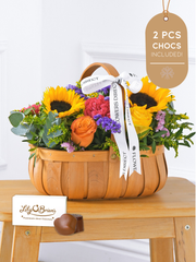 Colour Burst Basket 2 Pcs Chocs included! (old) – Brighten up any room with our "Colour Burst" arrangement, featuring stunning sunflowers, cerise carnations,...