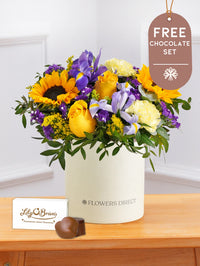 Iris Bliss - Hatbox with Free Chocolate Set – Bright and full of charm, Iris Bliss is a vibrant hatbox arrangement for any...
