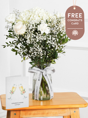 Pure Bliss - Vase with Free Congratulations Card – Indulge in the pure and serene beauty of our "Pure Bliss" arrangement, featuring pristine...