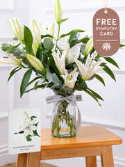 Sympathy White Lily - Vase with Free Sympathy card – An ethereal expression of solace: A graceful arrangement of pure White Lily and white...