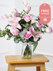 Pink Roses and Pink Lily Vase Free Upgrade –  This is a very elegant bouquet, featuring 6 large headed Pink roses with 2...