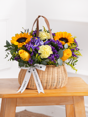 Iris Bliss Basket – The Iris Bliss – Basket is a cheerful mix of Blue Iris, Sunflowers, Yellow...