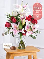 Anniversary Red Roses and Pink Lily - Vase with Chocolate Set –  This is a very elegant Anniversary bouquet, featuring large headed Naomi Red roses with...