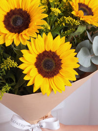 Sunshine Bunch! with Free Chocolate Set – Send a little sunshine with this cheerful arrangement of sunflowers and feathery yellow solidago....