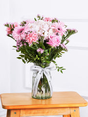Sympathy Sweetheart - Vase –  Delicately presented in a glass vase, harmonizing the soft hues of pink hydrangeas, gerberas,...