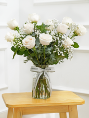 12 White Roses with a vase – Elevate the essence of elegance with our exquisite bouquet of 12 Long Stem White...