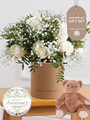 Anniversary White Roses - Hatbox Gift Set – Celebrate any special occasion with our stunning 12 white roses hatbox, elegantly complemented by gypsophillia and...