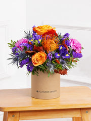 Crisp Meadow Hatbox – The Crisp Meadow Hatbox is an affordable seasonal delight, filled with vibrant orange roses,...