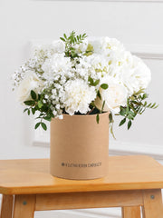 Pure Bliss Hatbox – Indulge in the pure and serene beauty of our "Pure Bliss" arrangement, featuring pristine...