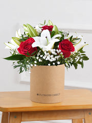 Red Roses and White Lily - Hatbox –  Our Red Roses and White Lily Hatbox is a bold and striking floral arrangement, featuring...